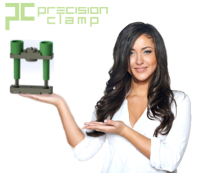 Woman in a white blouse hold an SCR Clamp she is facing the camera and smiling, she has long dark curly hair