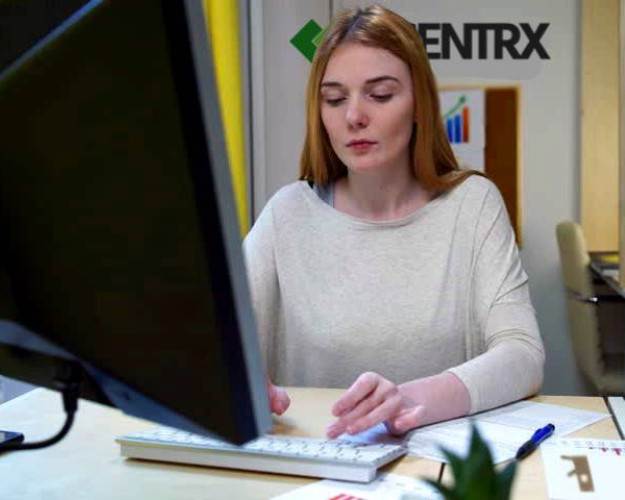 An image of a woman engineer Working On CAD software, she looks very happy and very professional.