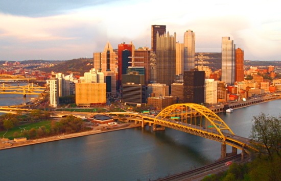An image of the Pittsburgh Skyline on a sunny day showing the 3 rivers, not a cloud in the sky